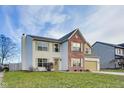 Two-story house with brick and vinyl siding, attached garage, and well-maintained lawn at 1171 Thornwood Dr, Greenwood, IN 46143