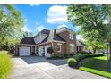 Elegant home features a three-car garage and an extended driveway, nestled in a landscaped yard at 3441 S Overlook Pass, New Palestine, IN 46163
