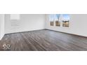 Spacious living room featuring gray wood floors and large windows for ample natural light at 1082 Stubble Run, Danville, IN 46122