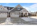 Attractive home with gray siding, a two-car garage, and a covered front porch at 16689 Cattle Hollow Ln, Noblesville, IN 46060