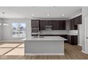 Modern kitchen with stainless steel appliances, a center island, and dark cabinetry at 16689 Cattle Hollow Ln, Noblesville, IN 46060