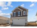 Two-story home featuring a two-car garage, attractive exterior colors, and professional landscaping at 1837 James Pierce Dr, Shelbyville, IN 46176