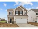 Charming two-story home featuring a two-car garage and stylish neutral color palette at 1837 James Pierce Dr, Shelbyville, IN 46176