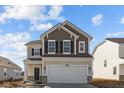 Charming two-story home featuring a two-car garage, attractive exterior colors, and great curb appeal at 1837 James Pierce Dr, Shelbyville, IN 46176