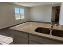 Kitchen featuring stainless steel sink, modern countertops, and an adjacent dining area at 3211 W Keepsake Ln, Monrovia, IN 46157