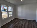 Bright living room featuring luxury vinyl plank flooring and a large window at 3211 W Keepsake Ln, Monrovia, IN 46157