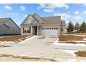 Beautiful single-Gathering home boasts a spacious driveway, two-car garage, and classic architectural details, offering comfort at 5006 Carmine St, Brownsburg, IN 46112