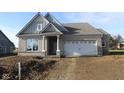 Newly built home with gray and beige brick exterior, two-car garage, and front porch at 5006 Carmine St, Brownsburg, IN 46112