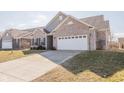 Well maintained home with an attached two-car garage and a large driveway at 5677 Starla Ln, Plainfield, IN 46168