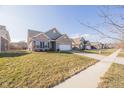 A street view of a well-maintained neighborhood with sidewalks, and landscaped yards at 5677 Starla Ln, Plainfield, IN 46168
