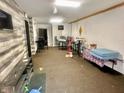 A large room with a bar, tables and chairs, with wall coverings and hard flooring at 1214 N Penn St, Muncie, IN 47303