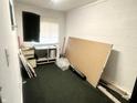 Vacant room with bare white walls, a window, and clutter at 1214 N Penn St, Muncie, IN 47303