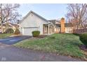 Traditional home with brick and white siding, attached garage, and landscaped front yard at 2856 Jamieson Ln, Indianapolis, IN 46268