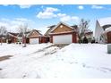 Snow covered exterior of a red brick and tan home community at 3538 Heathcliff Ct, Westfield, IN 46074