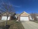 Tan and brick ranch home with attached garage at 3538 Heathcliff Ct, Westfield, IN 46074
