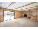 Inviting living room featuring a brick fireplace, sliding glass door, and built-in shelving at 7027 Creekside Ln, Indianapolis, IN 46220