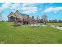 Sprawling backyard featuring a swimming pool, patio, screened in porch, and scenic pond at 3592 W Smokey Row Rd, Bargersville, IN 46106