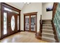 Inviting foyer featuring hardwood floors, elegant doors, and a staircase at 3592 W Smokey Row Rd, Bargersville, IN 46106