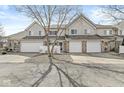 Townhouse complex with attached garages, vinyl siding, and well-kept lawns at 5845 Shipwatch Pl, Indianapolis, IN 46237