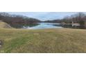 A serene view of a peaceful lake, surrounded by lush trees, reflecting a calming and natural setting at 7987 N Lasalle Rd, Morgantown, IN 46160