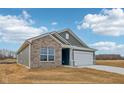 Attractive single-Gathering home featuring brick and siding, a two-car garage, and a well-manicured lawn at 113 Luna Pl, Shelbyville, IN 46176