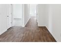 Bright hallway featuring hardwood flooring and white walls, offering a clean and modern aesthetic at 113 Luna Pl, Shelbyville, IN 46176