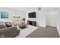 Inviting living room featuring neutral-toned furniture, bright light, and plush carpeting at 113 Luna Pl, Shelbyville, IN 46176