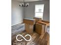Dining room boasts modern chandelier lighting fixture and new gray hardwood flooring at 1433 Wigwam Ln, Martinsville, IN 46151