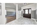 Bright entryway with dark brown door, tile floor, and hardwood floor at 2959 Hearthside Dr, Greenwood, IN 46143