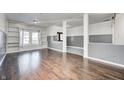 Spacious living room with hardwood floors, built-in shelves, and gray walls at 2959 Hearthside Dr, Greenwood, IN 46143