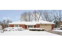 Brick ranch home with snow covered yard at 628 Folcroft Ct, Indianapolis, IN 46234