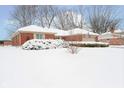 Brick ranch home with snow covered lawn at 628 Folcroft Ct, Indianapolis, IN 46234