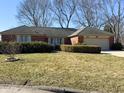 Lovely red brick ranch style home with a well kept yard on a sunny day at 628 Folcroft Ct, Indianapolis, IN 46234