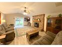 Cozy living room featuring a brick fireplace, ceiling fan, sliding glass door, and comfortable seating at 797 S Graveyard Rd, Paragon, IN 46166