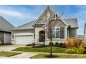 Gray and white two-story house with a white garage door and landscaping at 1915 Granville Dr, Westfield, IN 46074