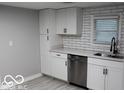 Modern white kitchen with stainless steel appliances at 231 S Routiers Ave, Indianapolis, IN 46219