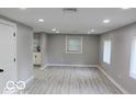 Bright living room with light gray walls and wood-look floors at 231 S Routiers Ave, Indianapolis, IN 46219