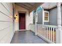 Inviting front porch with white railings and trim details adjacent to a neighbor's home at 2521 Prospect St, Indianapolis, IN 46203