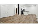 Open-concept living room with light wood floors flowing into the kitchen space at 2521 Prospect St, Indianapolis, IN 46203