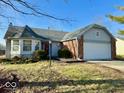 Brick ranch home with attached garage and landscaping at 7704 Winding Creek Dr, Indianapolis, IN 46236