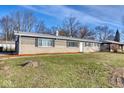 Ranch style home with brick exterior, landscaped lawn, and a spacious front yard at 8390 E Us 36 Hwy, Avon, IN 46123