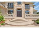 Grand entrance with stone archway, wrought iron balconies, and steps leading to the front door at 1023 Westview Point Dr, Columbus, IN 47201