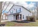 Two-story house with gray siding, brick accents, and a fenced backyard at 1127 Maple Stream Dr, Indianapolis, IN 46217