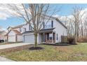 Two-story house with gray siding, brick accents, and a large front yard at 1127 Maple Stream Dr, Indianapolis, IN 46217