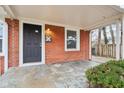 Inviting front porch with brick exterior and dark gray door at 2314 E 58Th St, Indianapolis, IN 46220