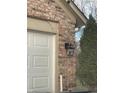 Brick garage with white door and black lantern at 2914 Rothe Ln, Indianapolis, IN 46229