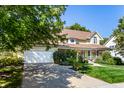 A charming yellow house with a white garage door and lush green landscaping at 6634 Royal Oakland Pl, Indianapolis, IN 46236