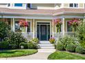 Inviting front porch with hanging flower baskets and a dark green front door at 6634 Royal Oakland Pl, Indianapolis, IN 46236
