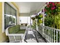 Relaxing front porch with wicker furniture and hanging plants at 6634 Royal Oakland Pl, Indianapolis, IN 46236