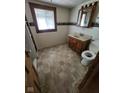 Bathroom with vanity, toilet, and tiled floor at 7739 Mooresville Rd, Indianapolis, IN 46183